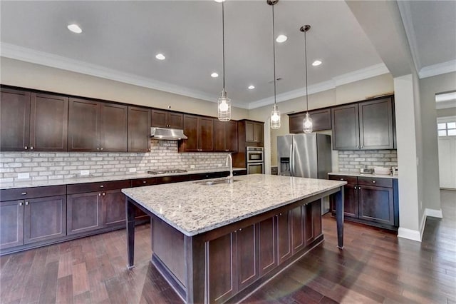 12095 Cameron Dr, Duluth, GA 30097 - kitchen featuring a sink, a breakfast bar, under cabinet range hood, a kitchen island with sink, and dark brown cabinetry