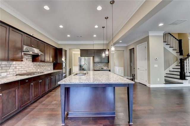 12095 Cameron Dr, Duluth, GA 30097 - kitchen featuring under cabinet range hood, crown molding, light stone countertops, a sink, and decorative backsplash