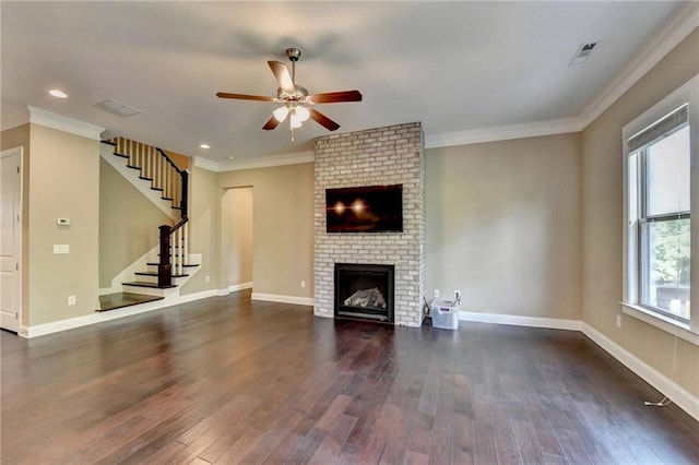 12095 Cameron Dr, Duluth, GA 30097 - unfurnished living room with a ceiling fan, dark wood finished floors, stairway, a brick fireplace, and crown molding