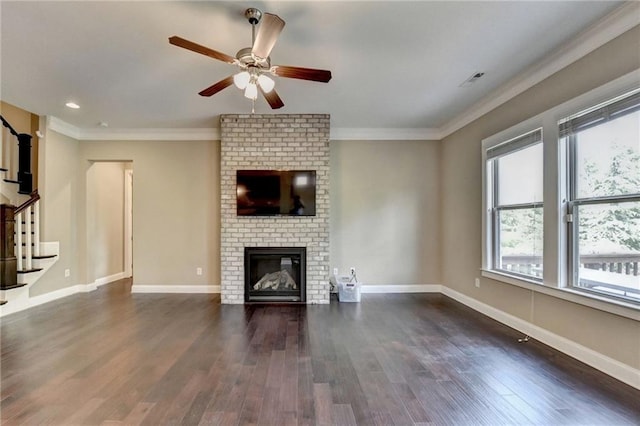 12095 Cameron Dr, Duluth, GA 30097 - unfurnished living room featuring a fireplace, dark wood-type flooring, ceiling fan, ornamental molding, and stairway