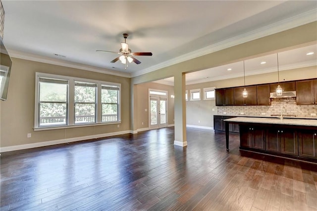 12095 Cameron Dr, Duluth, GA 30097 - unfurnished living room featuring a ceiling fan, dark wood-type flooring, baseboards, a sink, and crown molding