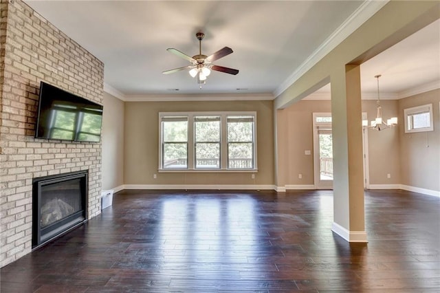 12095 Cameron Dr, Duluth, GA 30097 - unfurnished living room featuring a brick fireplace, a ceiling fan, a chandelier, dark wood-type flooring, and crown molding
