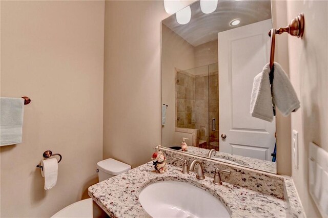 12095 Cameron Dr, Duluth, GA 30097 - bathroom featuring toilet, a stall shower, and vanity