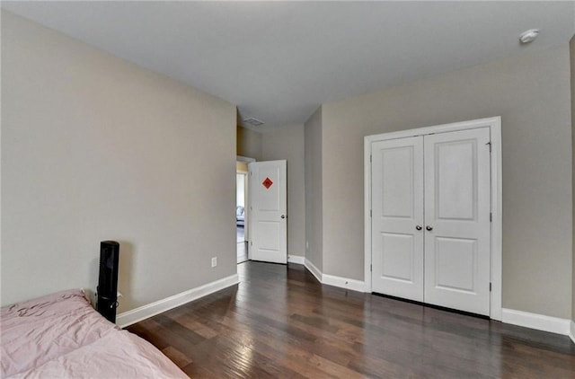 12095 Cameron Dr, Duluth, GA 30097 - bedroom with wood finished floors, baseboards, and a closet