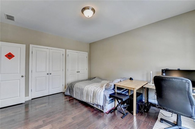12095 Cameron Dr, Duluth, GA 30097 - bedroom with multiple closets and wood finished floors