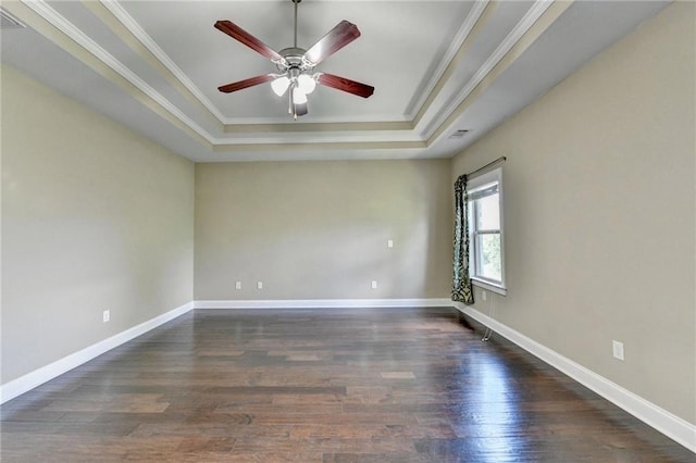 12095 Cameron Dr, Duluth, GA 30097 - spare room featuring a raised ceiling, ceiling fan, wood finished floors, ornamental molding, and baseboards