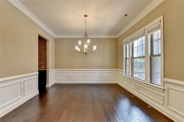 12095 Cameron Dr, Duluth, GA 30097 - unfurnished room with a chandelier, dark wood-type flooring, crown molding, a wainscoted wall, and a decorative wall