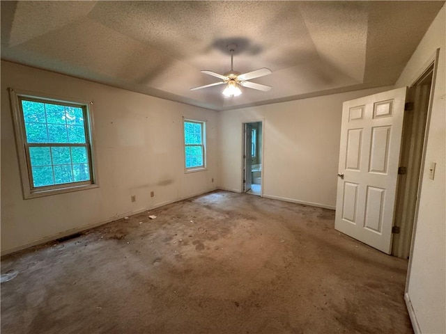 134 Summer Lake Dr, Dallas, GA 30157 - empty room featuring a tray ceiling, carpet floors, baseboards, ceiling fan, and a textured ceiling