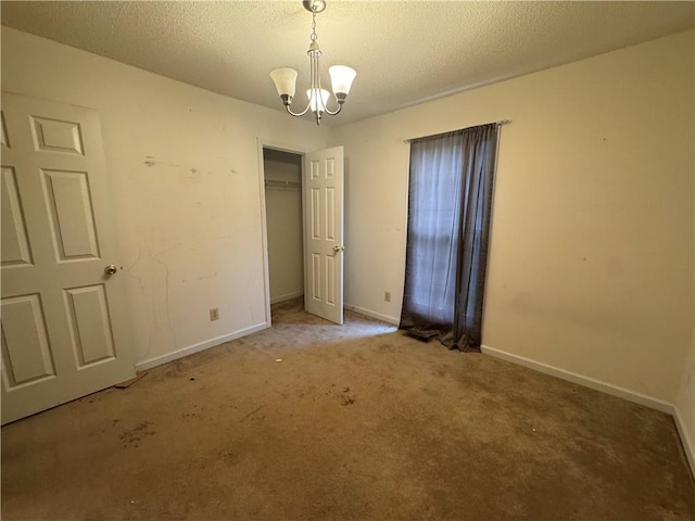 134 Summer Lake Dr, Dallas, GA 30157 - unfurnished bedroom with a closet, carpet flooring, a chandelier, a textured ceiling, and baseboards