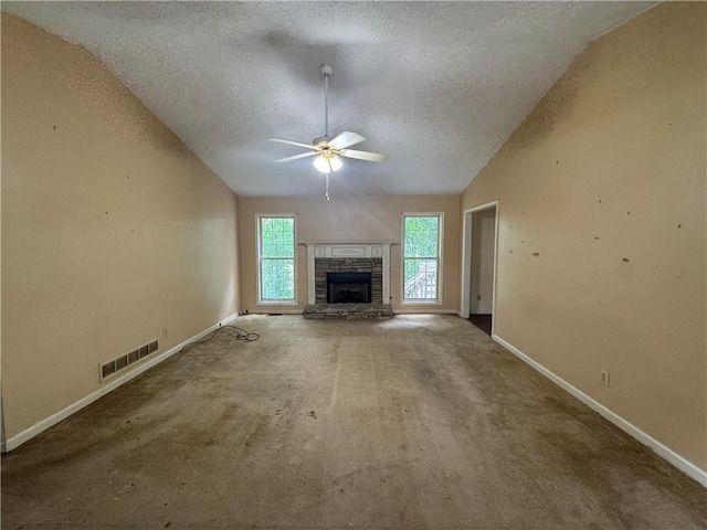 134 Summer Lake Dr, Dallas, GA 30157 - unfurnished living room with a textured ceiling, lofted ceiling, ceiling fan, baseboards, and a stone fireplace