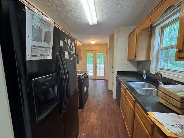 134 Summer Lake Dr, Dallas, GA 30157 - kitchen featuring black appliances, a sink, a textured ceiling, brown cabinetry, and dark wood-style floors