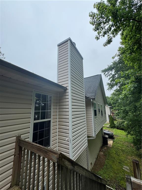 134 Summer Lake Dr, Dallas, GA 30157 - view of home's exterior featuring a chimney and a shingled roof
