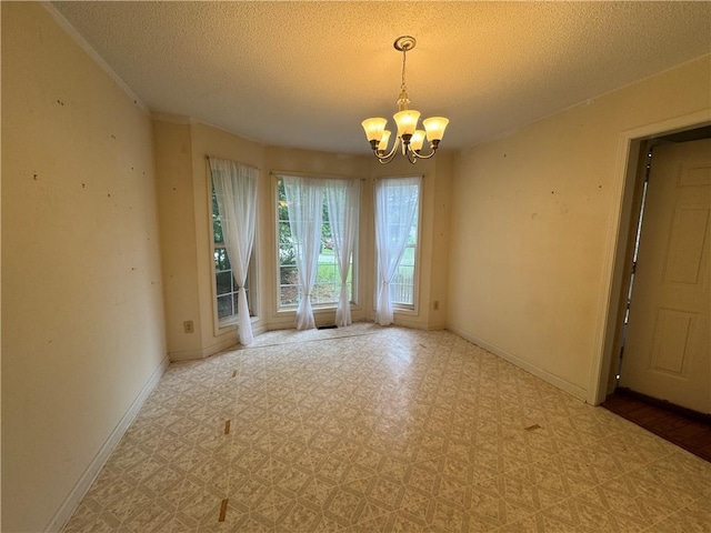 134 Summer Lake Dr, Dallas, GA 30157 - empty room with a chandelier, a textured ceiling, and baseboards