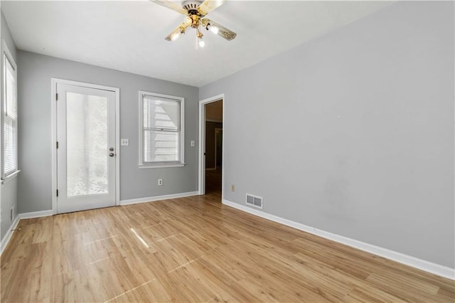 interior space featuring plenty of natural light, baseboards, visible vents, and light wood finished floors