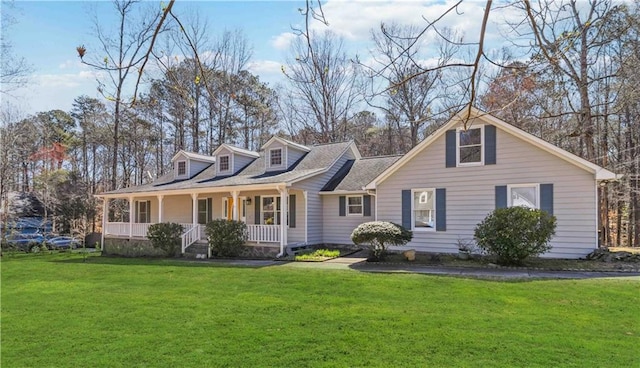 cape cod-style house featuring covered porch and a front yard