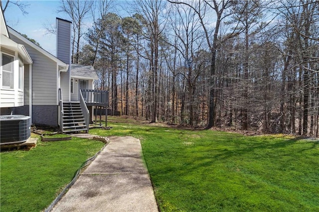 view of yard with stairway and central AC