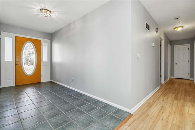 entrance foyer with baseboards and visible vents