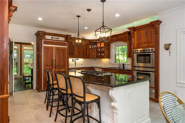 210 Hunters Vw, Roswell, GA 30075 - kitchen featuring stainless steel appliances, tasteful backsplash, crown molding, an island with sink, and hanging light fixtures