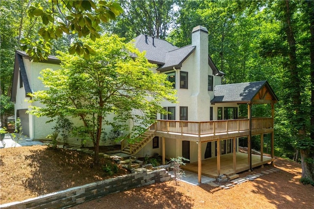 210 Hunters Vw, Roswell, GA 30075 - back of property with a deck, a chimney, stucco siding, a patio, and a shingled roof
