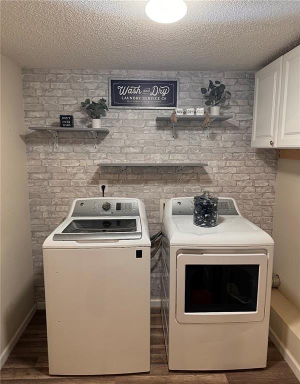 40 Legend Creek Chase, Douglasville, GA 30134 - washroom with washer and clothes dryer, cabinet space, wood finished floors, and a textured ceiling