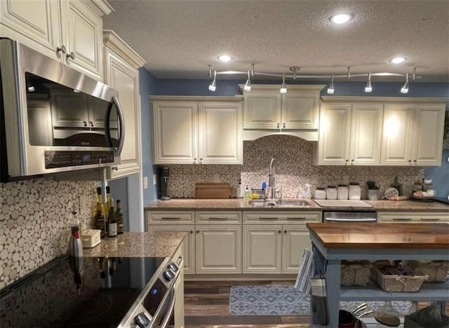 40 Legend Creek Chase, Douglasville, GA 30134 - kitchen with stainless steel appliances, a sink, tasteful backsplash, a textured ceiling, and dark wood finished floors