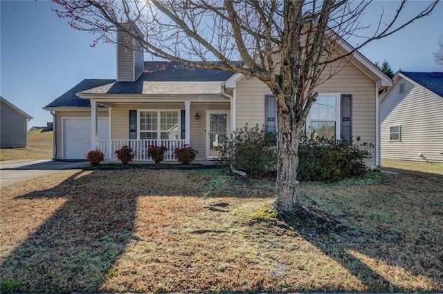 view of front of property with a front yard, covered porch, a chimney, a garage, and driveway