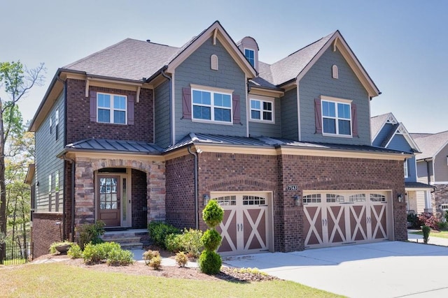 7143 Lake Edge Dr, Flowery Branch, GA 30542 - view of front of property featuring a garage, brick siding, a standing seam roof, and concrete driveway