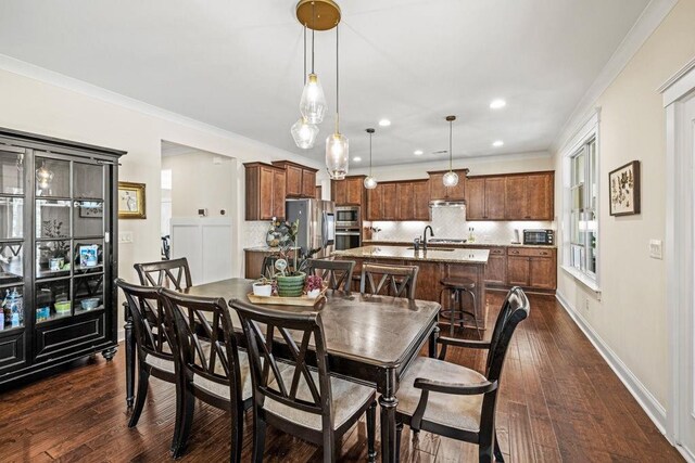 7143 Lake Edge Dr, Flowery Branch, GA 30542 - dining area featuring dark wood-type flooring, recessed lighting, ornamental molding, and baseboards
