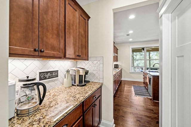7143 Lake Edge Dr, Flowery Branch, GA 30542 - kitchen with baseboards, recessed lighting, light stone counters, backsplash, and dark wood-style floors