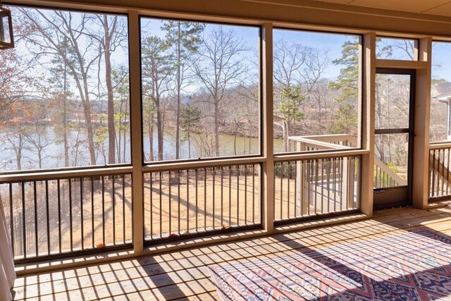 7143 Lake Edge Dr, Flowery Branch, GA 30542 - unfurnished sunroom with a water view