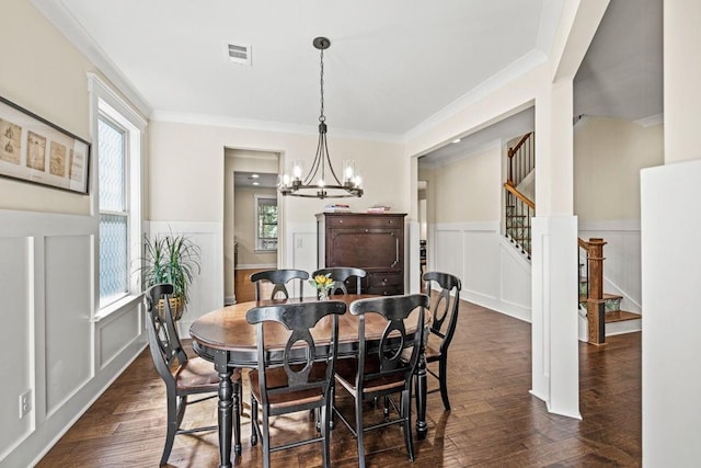 7143 Lake Edge Dr, Flowery Branch, GA 30542 - dining space featuring stairway, dark wood-type flooring, visible vents, a decorative wall, and wainscoting