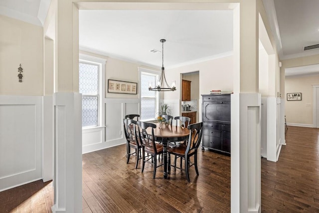7143 Lake Edge Dr, Flowery Branch, GA 30542 - dining space with visible vents, crown molding, dark wood-style floors, and wainscoting