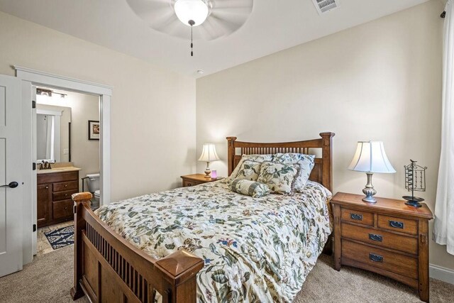 7143 Lake Edge Dr, Flowery Branch, GA 30542 - bedroom featuring a sink, visible vents, light carpet, a ceiling fan, and ensuite bath