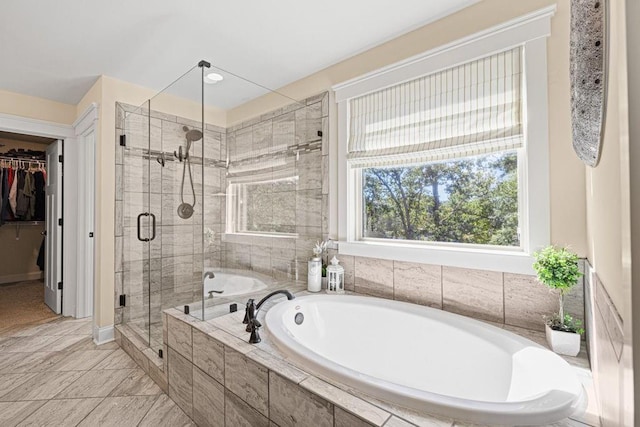7143 Lake Edge Dr, Flowery Branch, GA 30542 - full bath with a garden tub, a spacious closet, a shower stall, and baseboards