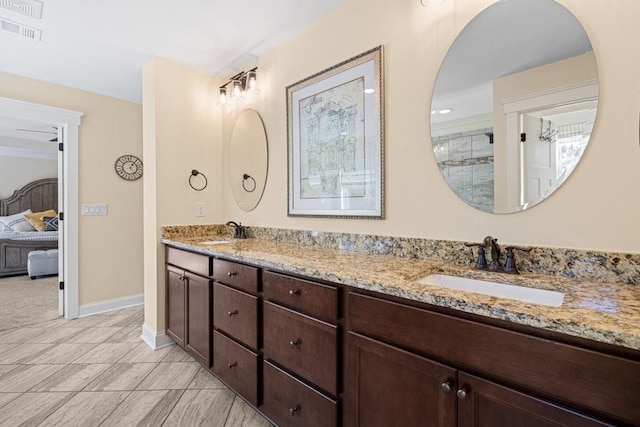 7143 Lake Edge Dr, Flowery Branch, GA 30542 - bathroom featuring double vanity, visible vents, ensuite bath, and a sink