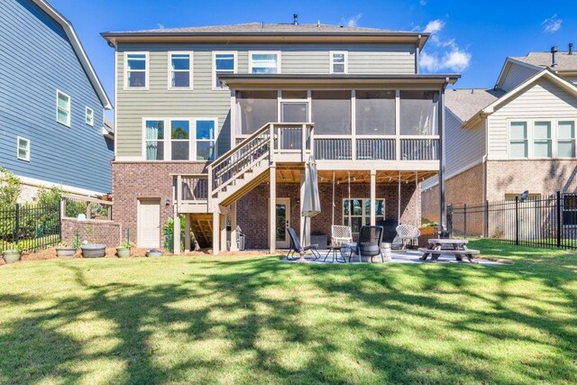 7143 Lake Edge Dr, Flowery Branch, GA 30542 - rear view of house featuring a sunroom, stairway, a patio area, brick siding, and fence