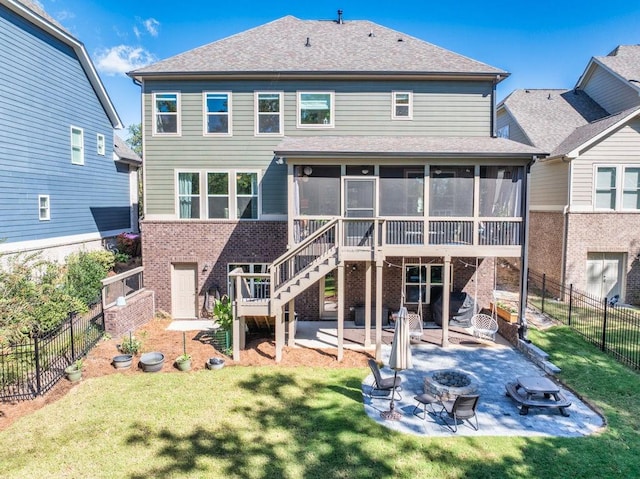 7143 Lake Edge Dr, Flowery Branch, GA 30542 - rear view of property with a patio area, an outdoor fire pit, a yard, brick siding, and a sunroom