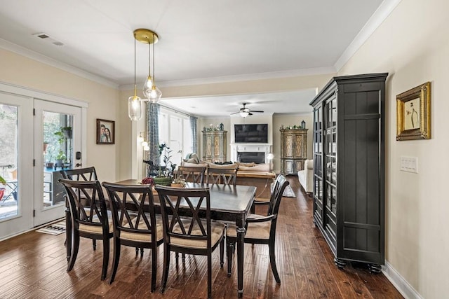 7143 Lake Edge Dr, Flowery Branch, GA 30542 - dining room featuring visible vents, baseboards, ornamental molding, dark wood finished floors, and a fireplace