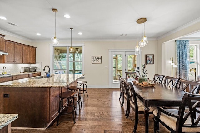 7143 Lake Edge Dr, Flowery Branch, GA 30542 - dining space with ornamental molding, visible vents, baseboards, and dark wood-type flooring