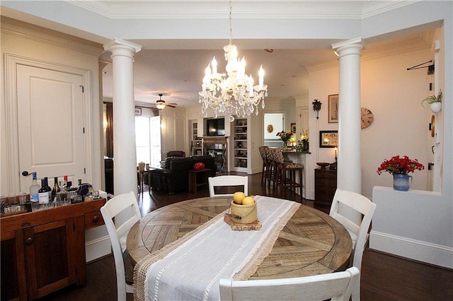 dining area featuring ceiling fan with notable chandelier, ornamental molding, a fireplace, and decorative columns