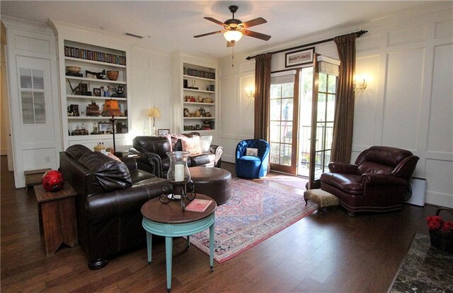 living room with plenty of natural light, dark hardwood / wood-style floors, built in features, and ceiling fan