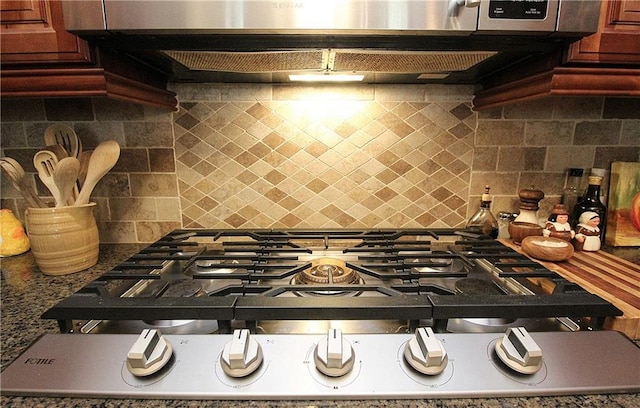 kitchen featuring backsplash, ventilation hood, and stainless steel gas cooktop