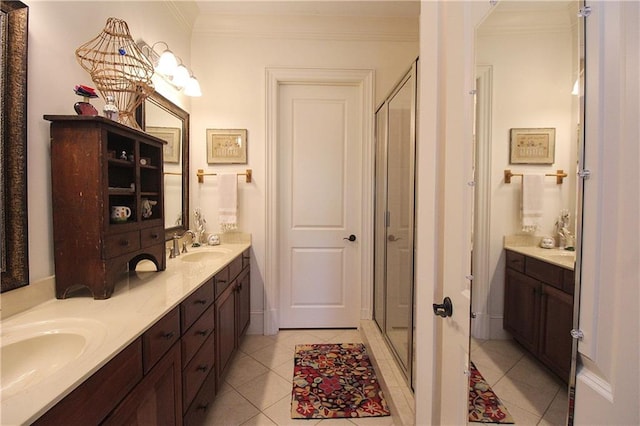 bathroom with tile patterned flooring, crown molding, an enclosed shower, and vanity