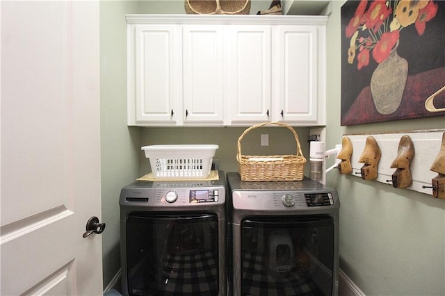 clothes washing area with cabinets and independent washer and dryer