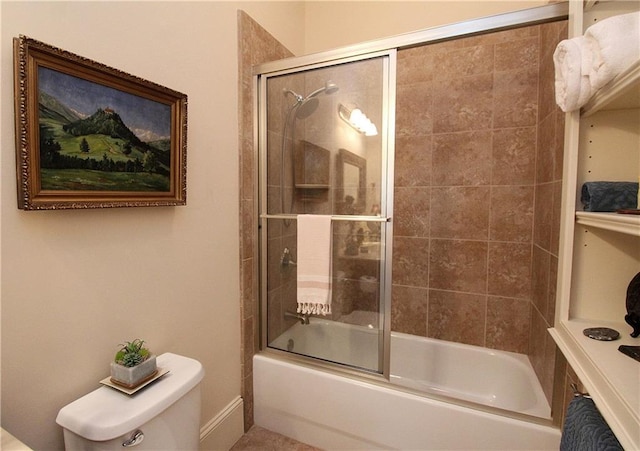 bathroom featuring bath / shower combo with glass door and toilet