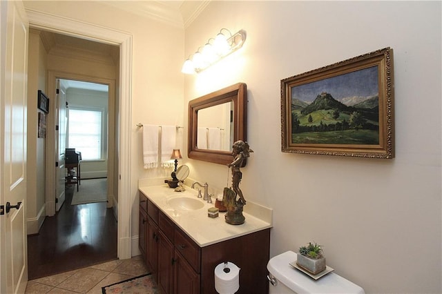 bathroom featuring vanity, tile patterned floors, ornamental molding, and toilet