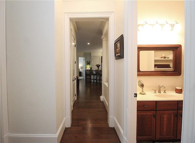 corridor featuring dark hardwood / wood-style flooring and sink