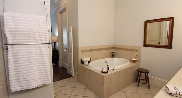 bathroom with tile patterned flooring and tiled bath