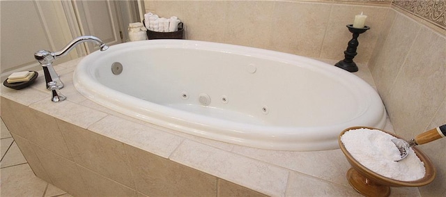 bathroom with tile patterned flooring and tiled bath