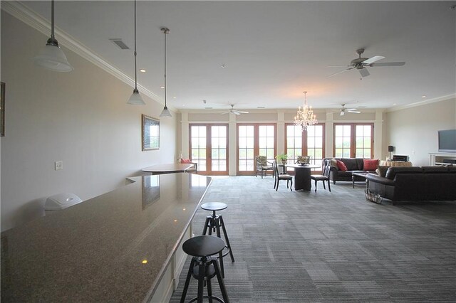 interior space with an inviting chandelier, crown molding, and carpet floors